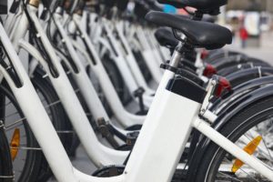 Urban electric bikes charging batteries in the city. To rent